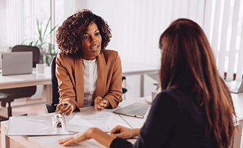 Businesswoman meeting with a client across a desk in an office