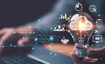 Hand holding a glowing lightbulb surrounded by icons representing cloud technology, analytics, and collaboration