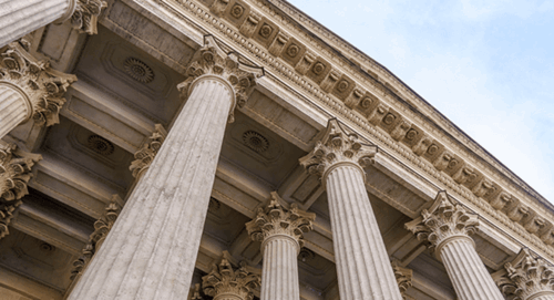 Close-up of classical stone columns and cornice on a government or courthouse building