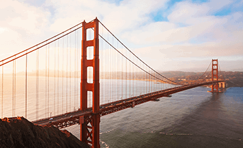 Golden Gate Bridge spanning the water at sunset