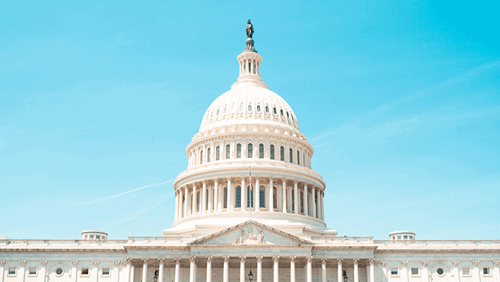 U.S. Capitol Building dome against a clear blue sky